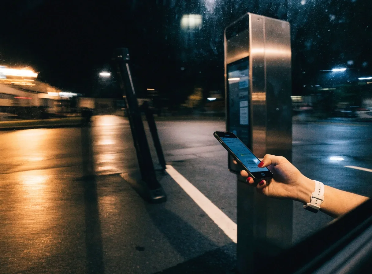 Tapping with Google Pay at an airport parking entry lane at night